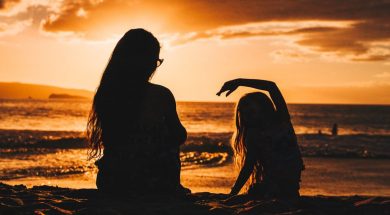 Woman-and-daughter-on-beach-at-sunset.jpg